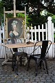 Old French bistro table with black iron base and old wooden top...