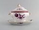 Early and rare Bing & Grøndahl lidded tureen in hand-painted porcelain with 
purple flowers and gold decoration. Lid bud modeled as a rosebud. Early 20th 
century.
