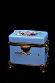 K&Co. presents: Antique sugar box in opaline glass painted in blue with fine floral motifs and bronze mounting...