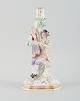 Large antique Meissen candlestick in hand-painted porcelain decorated with 
flowers, insects and birds. Man and girl.
19th century.