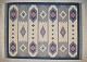 Swedish handwoven wool rug with fringes in the "Rölakan" technique.
Geometric shapes in light blue, dark blue, and pink on a white background.