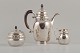 Rare Georg Jensen coffee pot with matching creamer and sugar bowl in 
sterlingsilver and three-towered silver (830 silver).