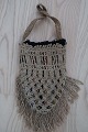 An antique beautiful handbag handmade of flax, and 
it has the characteristic colour of  flax 
The closing is made with a string, handmade as 
well