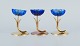 Gunnar Ander for Ystad Metall. Two candlesticks in brass and blue art glass 
shaped like flowers.
1950s.