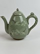 Small Chinese teapot with green cracked celadon glaze with cranes and clouds.