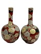 Pair of Asian vases, presumably Japanese. 20th 
century. Iron glaze with flowers.