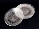 Murano, Italy, a set of four small plates in clear glass with spiral-shaped gold 
decoration.