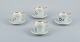 Bing & Grøndahl, a set of four antique coffee cups with high handles and  
saucers. Hand-painted with polychrome flower decoration. Porcelain of strong 
quality.