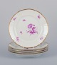 Bing & Grøndahl, Denmark. A set of five luncheon plates with flower decorations 
in purple and gold trim. Hand-painted.