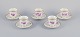 Bing & Grøndahl, Denmark. A set of five coffee cups and saucers with flower 
decorations in purple and gold trim. Hand-painted.