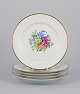 Bing & Grøndahl, Denmark. A set of five porcelain plates hand-painted with 
various polychrome flower motifs and gold rim.