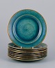 Josef Ekberg for Gustavsberg, Sweden. A set of ten ceramic plates with glaze in 
blue-green tones and a gold rim.