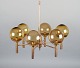 Sv. Mejlstrøm, Danish designer. Brass chandelier with six arms and dome-shaped 
shades made of amber-colored glass.
