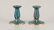 Josef Ekberg (1877-1945) for Gustavsberg, Sweden. A pair of candle holders with 
glaze in green-blue tones, gold decoration.