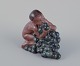 Kai Nielsen (1882-1924) for Bing & Grøndahl. Stoneware figurine depicting 
"Little Bacchus with Grapes".  From the Grape Harvest Series.