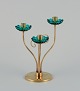 Gunnar Ander for Ystad Metall, Sweden. Brass candlestick holder with turquoise 
glass sleeves. For three candles.