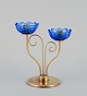 Gunnar Ander for Ystad Metall, Sweden. Brass candlestick holder with blue glass 
sleeves. For two candles.
