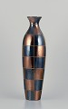 French ceramic artist. Large unique ceramic vase in a modernist design.
Square sections in blue and gold-tone glossy glaze.