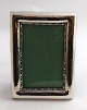 Silver photo frame (830). Measures 9*12 cm. Measurements for photo 5.5*8.6 cm. 
Produced 1932.