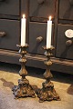 A pair of old 
Rocco 
candlesticks in 
metal with a 
super ...