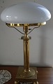 Table lamp of brass with milky white glass screen and on a square foot