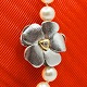 Antik 
Damgaard-
Lauritsen 
presents: 
Ole 
Lynggaard, 
Charlotte 
Lynggaard; 
Clasp of 14k 
white gold with 
a diamond