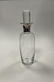 Holmegaard 
Karaffel i 
klart glas med 
sølv hals