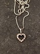 14 carat white 
gold heart 
pendant with 
several 
diamonds