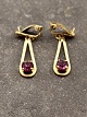 A pair of 
gold-plated 
earrings with 
amethyst