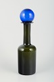 Otto Brauer for Holmegaard. Large bottle vase in bottle-green art glass with 
blue stopper.
