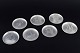 L'Art presents: 
Just 
Andersen, 
Denmark.
Set of seven 
pewter bottle 
coasters.