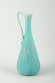Rörstrand, Sweden
Pitcher in turquoise glaze with ribbed body and elegantly curved handle.