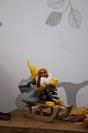 K&Co. presents: 
Old gnome 
on a wooden 
sled...