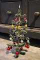 K&Co. presents: 
Antique 
miniature 
Christmas tree, 
decorated with 
lots of small 
colored 
Christmas glass 
balls...