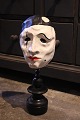 K&Co. presents: 
Decorative, 
old clown mask 
in painted 
papier-mâché 
mounted on old 
black painted 
wooden base...