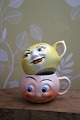 K&Co. presents: Old children's cups in faience with funny faces. 1 yellow and 1 light red...