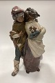 Danam Antik presents: Lladro Stoneware Figurine of Girl and Boy with Dog - Facing the Wind