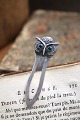 K&Co. presents: Old silver bookmark in the shape of a small owl with green glass eyes. Stamped 830s.
