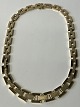 Block necklace with embossing in the middle row. Stamped ...