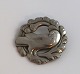 Lundin Antique presents: Georg Jensen. Brooch with dove in sterling silver (925). Diameter 4 cm.