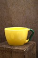 K&Co. presents: Ursula teacup in faience from Royal Copenhagen designed by Ursula Munch-Petersen in yellow glaze...