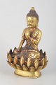 L'Art presents: Gilt bronze Buddha figure.