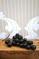 K&Co. presents: Old bunch of grapes with dark grapes made of cast glass material.