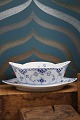 K&Co. presents: Boat-shaped sauce bowl on a solid saucer in Blue Fluted Half Lace from Royal Copenhagen...