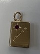 Antik Huset presents: 14 karat gold. Book with inlaid red ruby.Charms / Pendants.Height 1.9 cm.