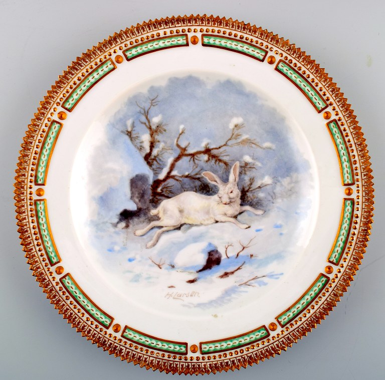 Royal Copenhagen Flora Danica / fauna Danica dinner plate decorated with an 
arctic hare in winter landscape.