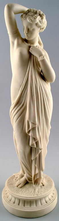 Antique large biscuit figure of semi-nude woman in classical style.
