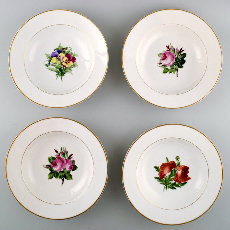 4 antique Royal Copenhagen deep plates in flora danica style.
