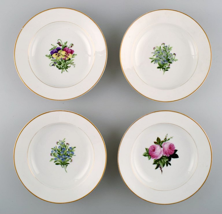 4 antique Royal Copenhagen deep plates in flora danica style.
