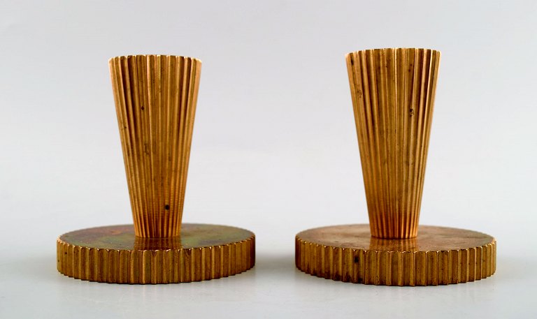 Tinos art deco, a pair of candlesticks in bronze.